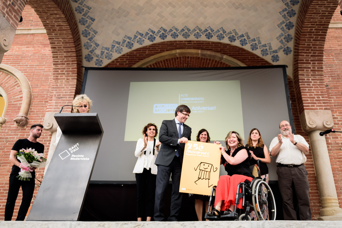 El president de la Generalitat, Carles Puigdemento, lliurament a Pilar Díaz, la litografia cedida per Javier Mariscal, per als homenatjats de Amputats Sant Jordi. Pilar Díaz López, presidenta de COCEMFE Barcelona, va ser homenatjada ahir a l'acte del 25 Aniversari de l'Associació Amputats Sant Jordi, que va presidir durant 14 anys.